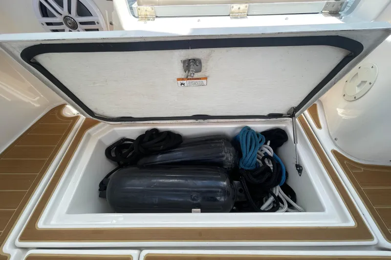 Motivated Yacht Photos Pics Storage compartment on 2022 Cutwater C-32 CB boat with ropes and fenders.