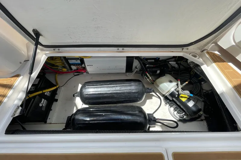 Motivated Yacht Photos Pics 2022 Cutwater C-32 CB engine compartment with batteries and mechanical components.