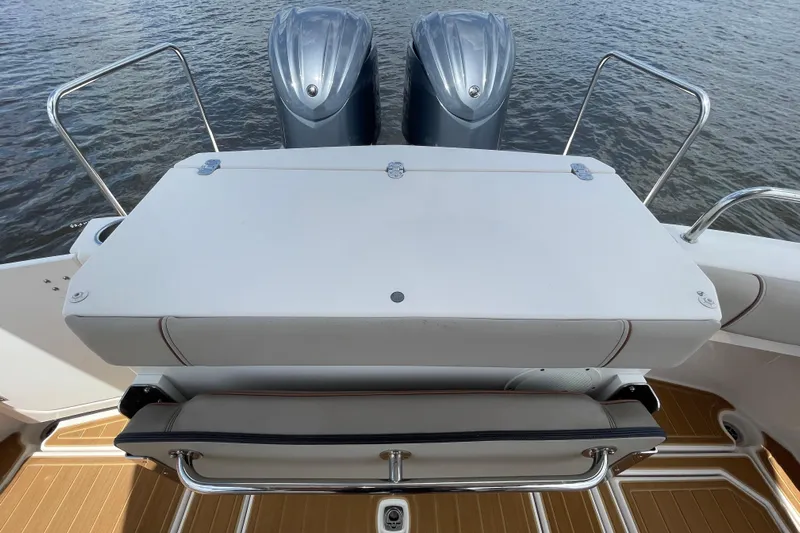 Motivated Yacht Photos Pics 2022 Cutwater C-32 CB boat stern with dual engines and seating area.