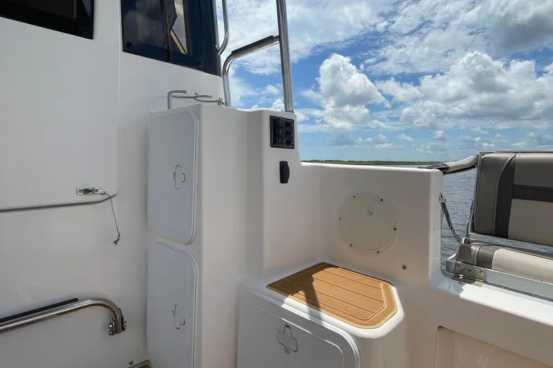 Motivated Yacht Photos Pics 2022 Cutwater C-32 CB boat interior with seating, storage, and scenic water view.