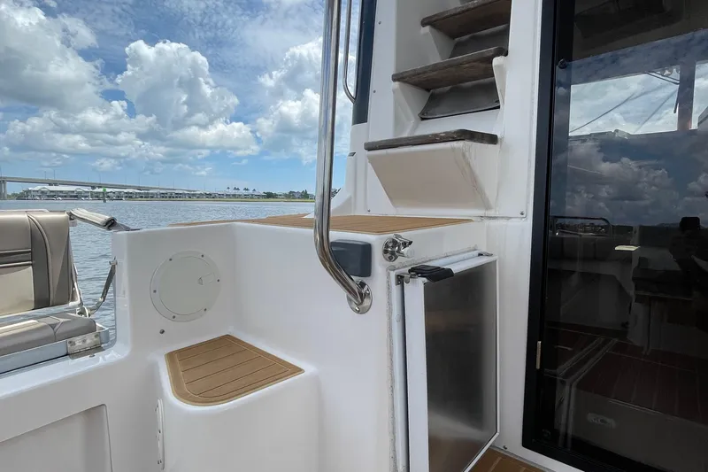 Motivated Yacht Photos Pics 2022 Cutwater C-32 CB boat interior with stairs, seating, and water view.