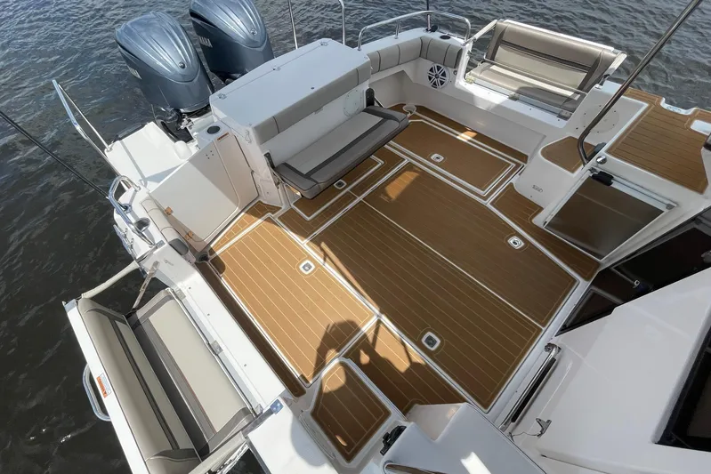 Motivated Yacht Photos Pics 2022 Cutwater C-32 CB boat deck with seating and twin engines on water.