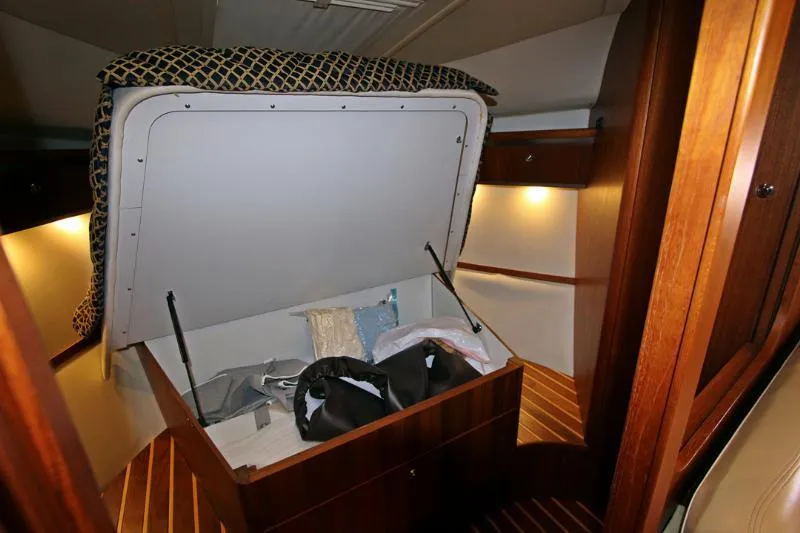  Yacht Photos Pics 2005 Tiara Yachts 3600 Sovran cabin storage area with open compartment and wooden interior.