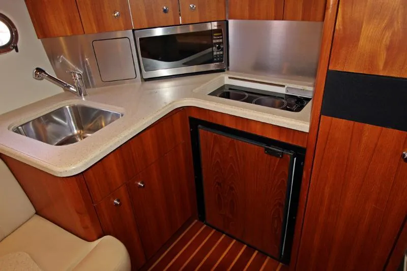  Yacht Photos Pics 2005 Tiara Yachts 3600 Sovran galley with sink, microwave, stove, and fridge.