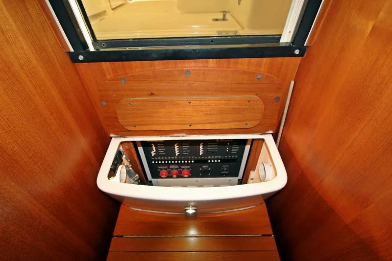  Yacht Photos Pics Electrical panel inside 2005 Tiara Yachts 3600 Sovran, featuring wooden cabinetry and control switches.