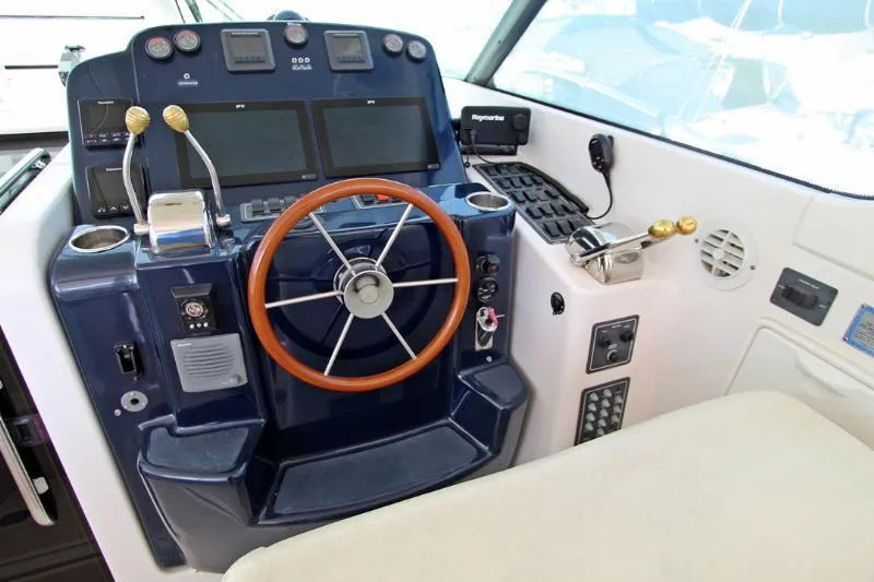  Yacht Photos Pics 2005 Tiara Yachts 3600 Sovran helm with steering wheel and navigation controls.