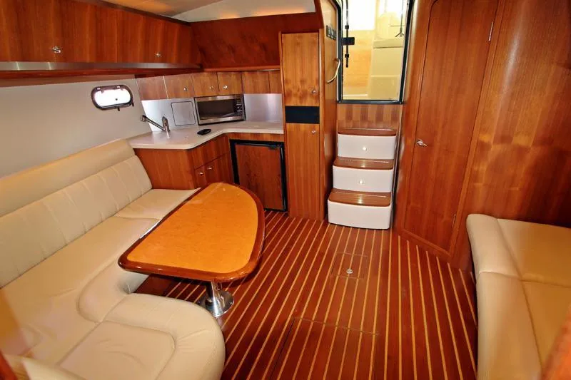  Yacht Photos Pics 2005 Tiara Yachts 3600 Sovran interior with wood finish, seating, and kitchenette.