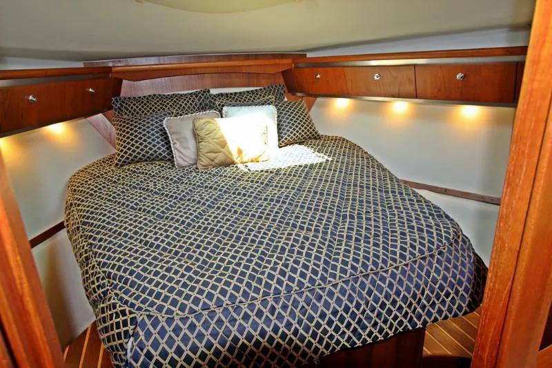  Yacht Photos Pics Luxurious cabin interior of 2005 Tiara Yachts 3600 Sovran with cozy bedding and ambient lighting.