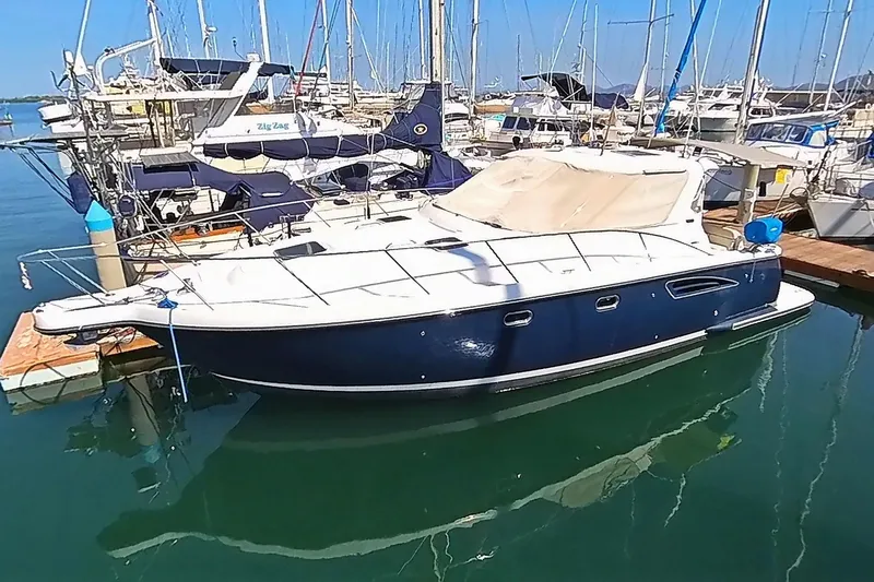  Yacht Photos Pics 2005 Tiara Yachts 3600 Sovran docked in a marina, surrounded by sailboats.