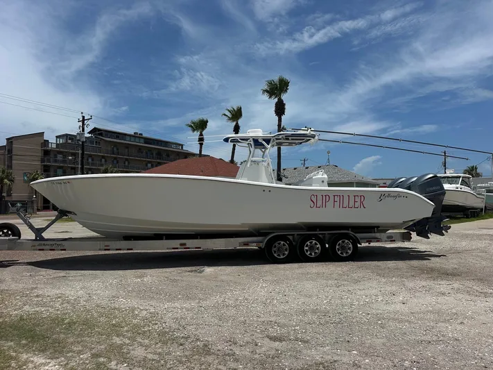  Yacht Photos Pics 2012 Yellowfin 36 Offshore boat on trailer, labeled "Slip Filler," parked outdoors.