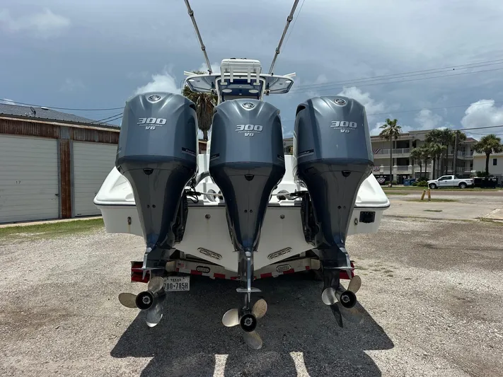  Yacht Photos Pics 2012 Yellowfin 36 Offshore boat with triple 300 V6 outboard engines, parked outdoors.