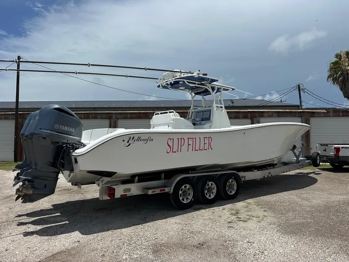  Yacht Photos Pics 2012 Yellowfin 36 Offshore boat on trailer, featuring Yamaha engines, parked outdoors.