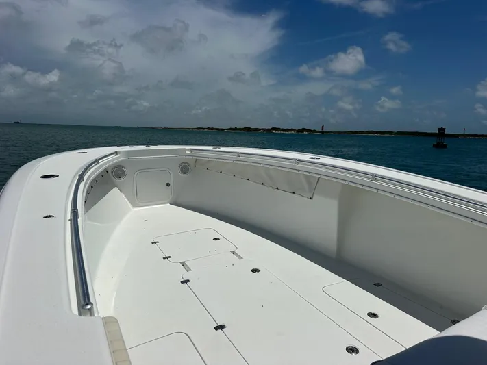  Yacht Photos Pics 2012 Yellowfin 36 Offshore boat on calm ocean under blue sky.
