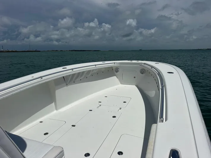  Yacht Photos Pics 2012 Yellowfin 36 Offshore boat on calm ocean under cloudy sky.
