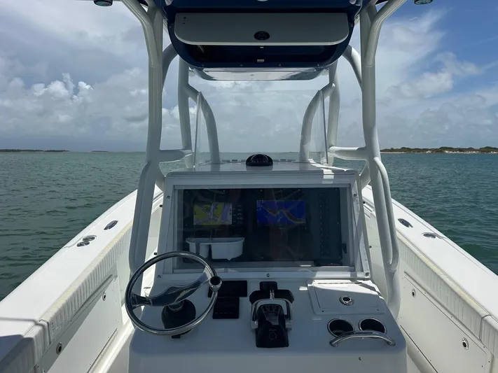  Yacht Photos Pics 2012 Yellowfin 36 Offshore boat dashboard with navigation system on open water.