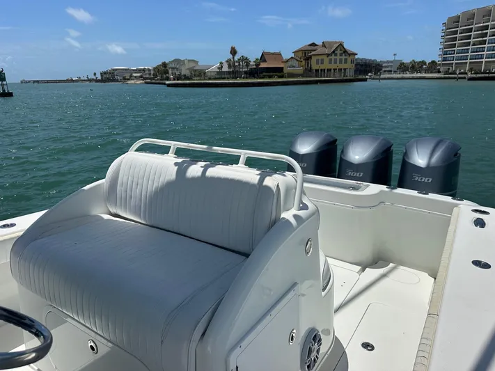  Yacht Photos Pics 2012 Yellowfin 36 Offshore boat with triple 300 engines, docked near waterfront buildings.