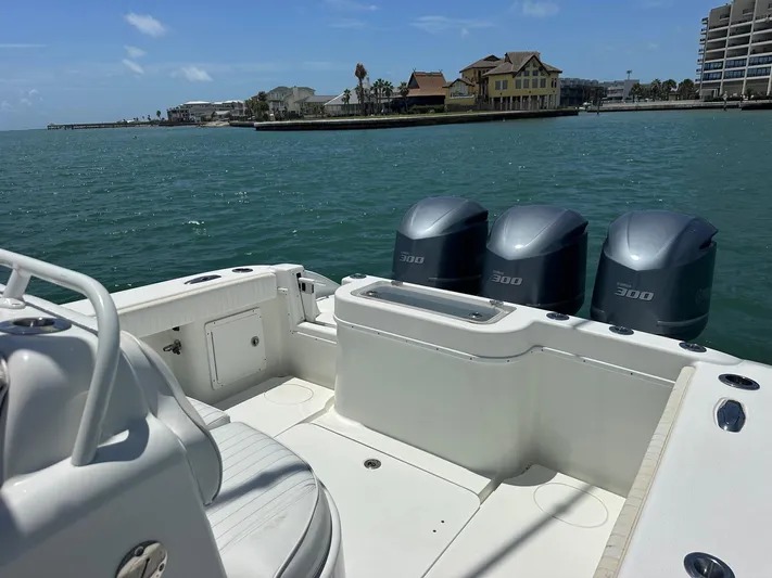  Yacht Photos Pics 2012 Yellowfin 36 Offshore boat with triple 300 horsepower engines on calm water.