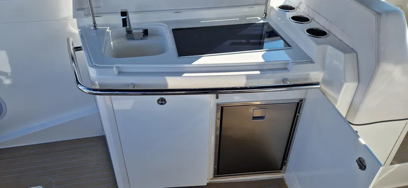  Yacht Photos Pics Outdoor kitchenette on 2024 Windy 40 Camira RS yacht with sink and storage.
