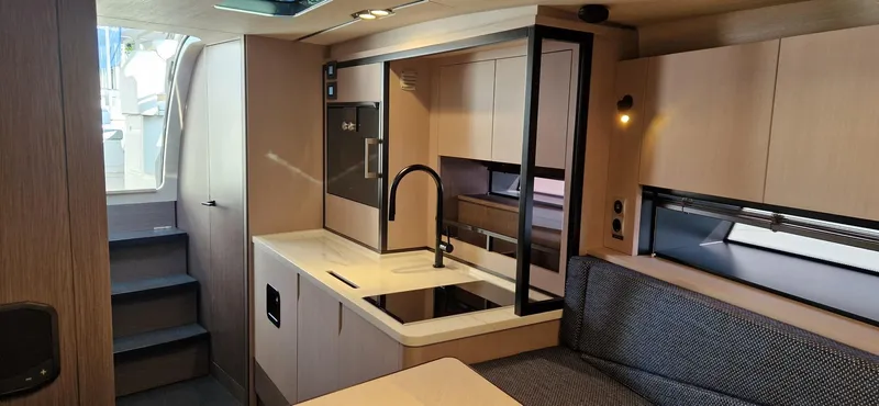  Yacht Photos Pics Modern interior of 2024 Windy 40 Camira RS yacht with sleek kitchen and seating area.