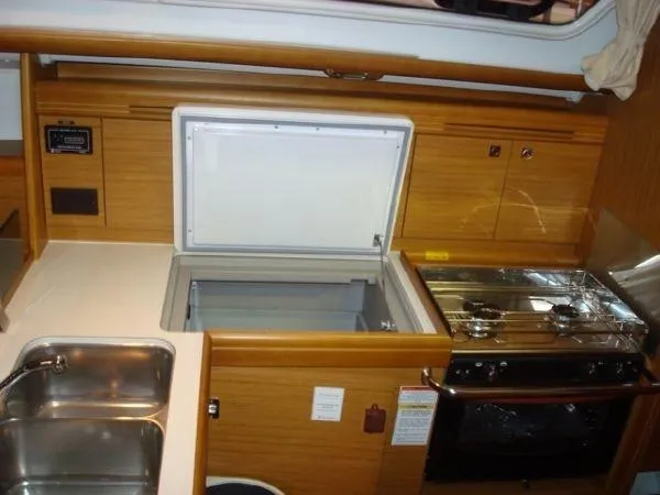 For Grins Too Yacht Photos Pics Interior of 2010 Jeanneau Sun Odyssey 36i yacht kitchen with stove and sink.