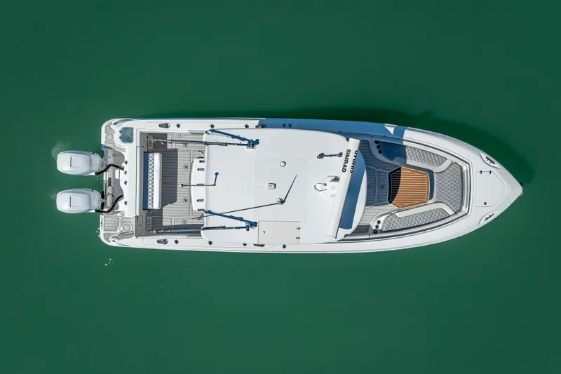 High Voltage Yacht Photos Pics Aerial view of 2013 Boston Whaler 320 Outrage boat on green water.