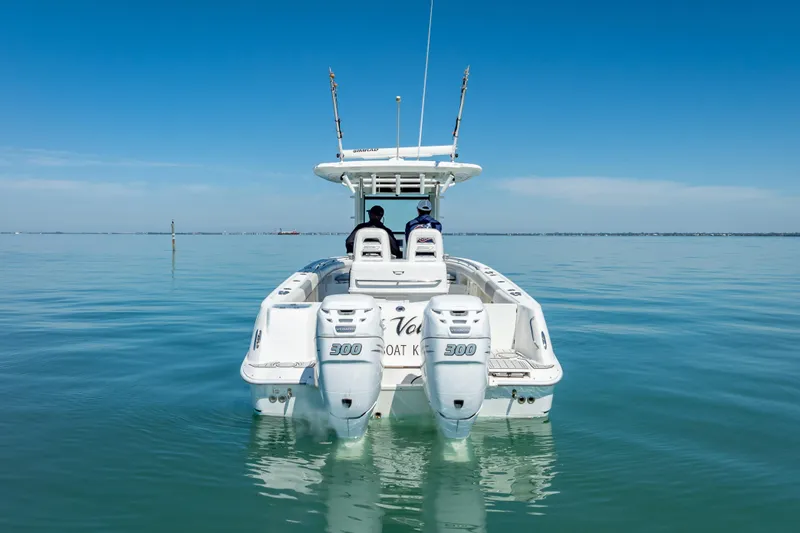 High Voltage Yacht Photos Pics 2013 Boston Whaler 320 Outrage on calm water, rear view with dual engines.
