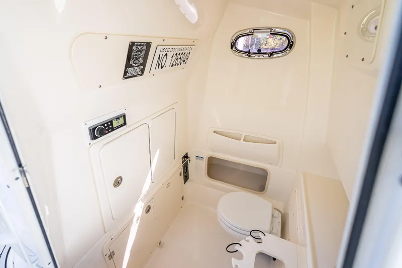 High Voltage Yacht Photos Pics Interior of 2013 Boston Whaler 320 Outrage boat with compact marine toilet.
