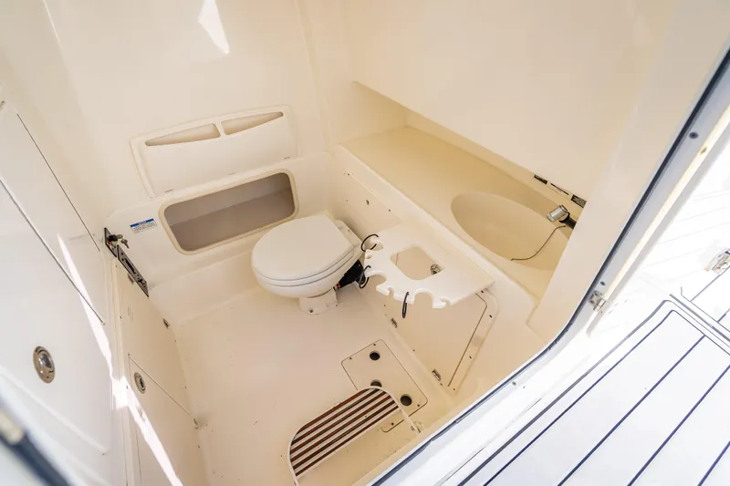 High Voltage Yacht Photos Pics 2013 Boston Whaler 320 Outrage boat bathroom interior with toilet and sink.