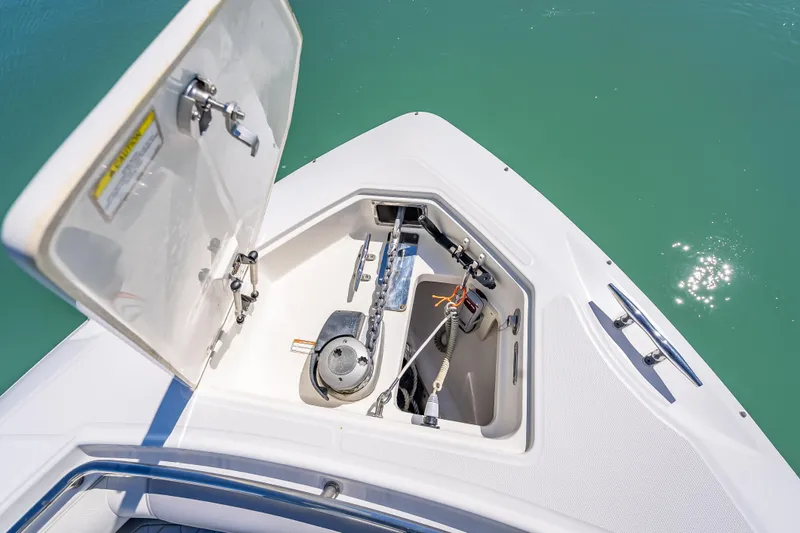 High Voltage Yacht Photos Pics Open anchor compartment on 2013 Boston Whaler 320 Outrage, showing anchor and chain mechanism.