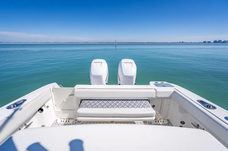 High Voltage Yacht Photos Pics 2013 Boston Whaler 320 Outrage boat with dual engines on calm water.