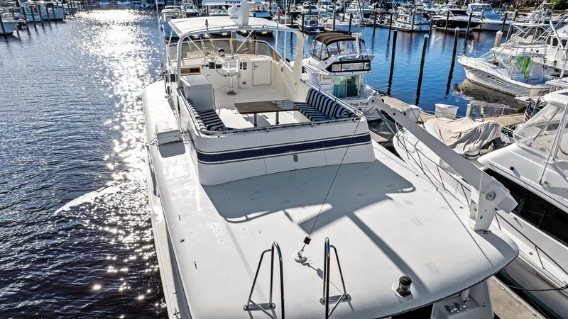Airwaves Yacht Photos Pics 1987 Hatteras 68 Cockpit Motor Yacht docked at marina, sunny day.