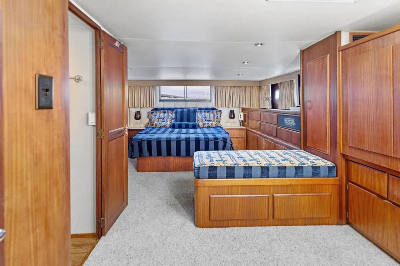 Airwaves Yacht Photos Pics Interior of 1987 Hatteras 68 Cockpit Motor Yacht with twin beds and wood paneling.