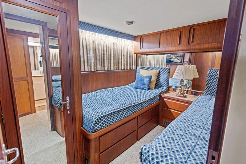 Airwaves Yacht Photos Pics Interior of 1987 Hatteras 68 Cockpit Motor Yacht with twin beds and wooden cabinetry.