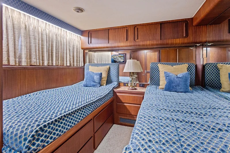 Airwaves Yacht Photos Pics Interior of 1987 Hatteras 68 Cockpit Motor Yacht with twin beds and wooden paneling.