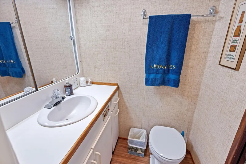 Airwaves Yacht Photos Pics Bathroom interior of 1987 Hatteras 68 Cockpit Motor Yacht with sink and toilet.