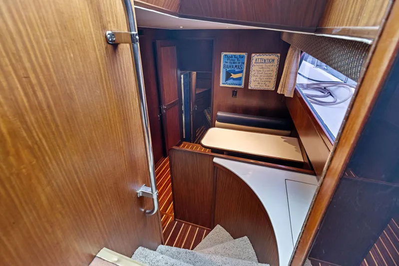 Airwaves Yacht Photos Pics Interior of 1987 Hatteras 68 Cockpit Motor Yacht with wood paneling and cozy seating area.