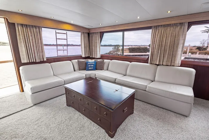 Airwaves Yacht Photos Pics Luxurious interior of 1987 Hatteras 68 Cockpit Motor Yacht with spacious seating and large windows.