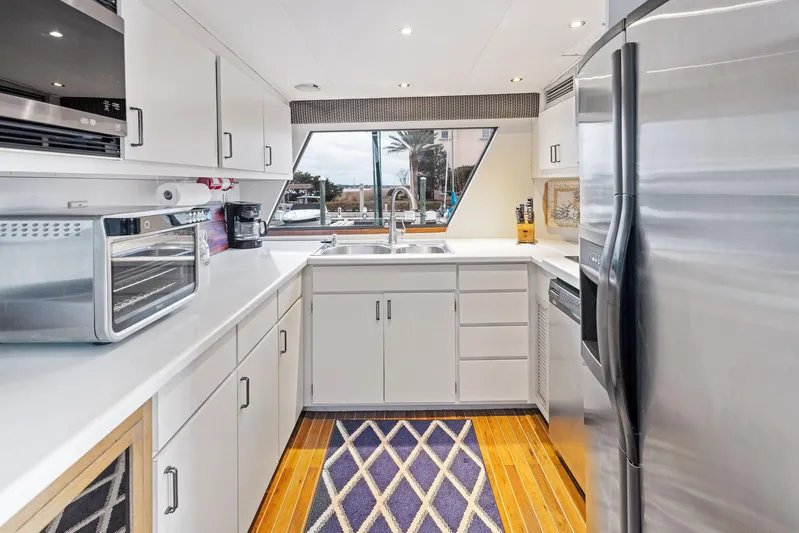 Airwaves Yacht Photos Pics Modern kitchen in 1987 Hatteras 68 Cockpit Motor Yacht with stainless steel appliances.