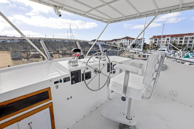 Airwaves Yacht Photos Pics Helm of 1987 Hatteras 68 Cockpit Motor Yacht with marina view.