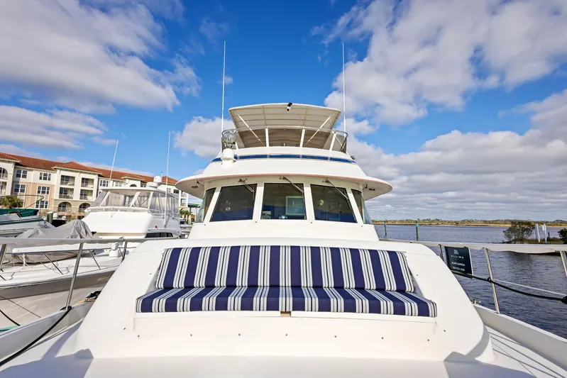 Airwaves Yacht Photos Pics 1987 Hatteras 68 Cockpit Motor Yacht docked under blue sky.