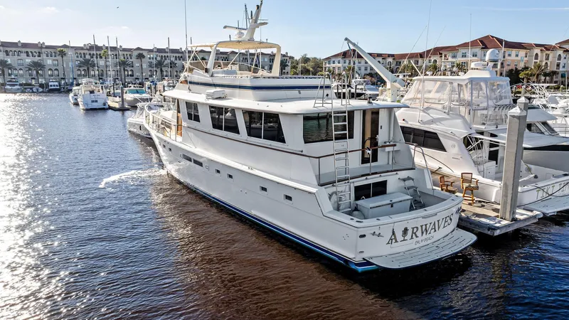 Airwaves Yacht Photos Pics 1987 Hatteras 68 Cockpit Motor Yacht docked in marina, surrounded by other boats.