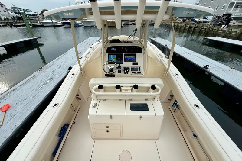 Neverland II Yacht Photos Pics 2022 Grady-White Canyon 271 boat interior at dock, featuring helm and seating area.