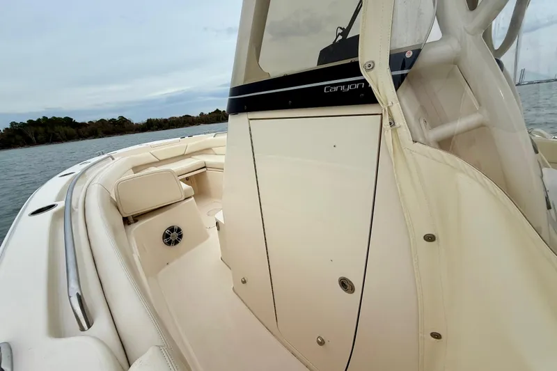 Neverland II Yacht Photos Pics 2022 Grady-White Canyon 271 boat interior with seating and console, on calm water.