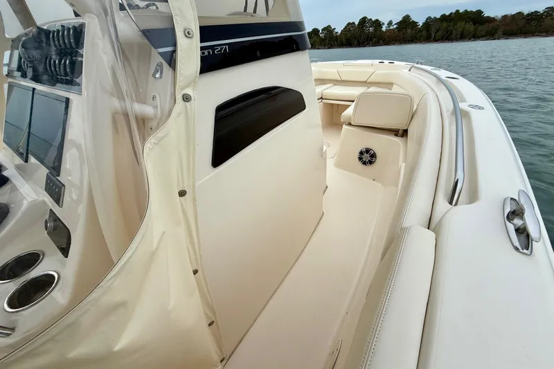 Neverland II Yacht Photos Pics 2022 Grady-White Canyon 271 boat interior with seating and control panel on water.