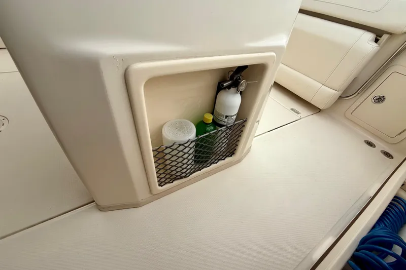Neverland II Yacht Photos Pics Storage compartment on 2022 Grady-White Canyon 271 boat with fire extinguisher and supplies.