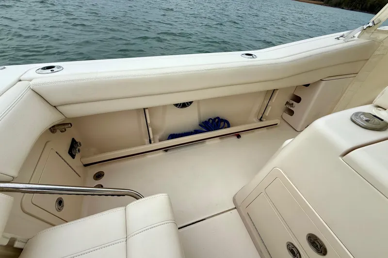 Neverland II Yacht Photos Pics 2022 Grady-White Canyon 271 boat interior with white seating and storage compartments.