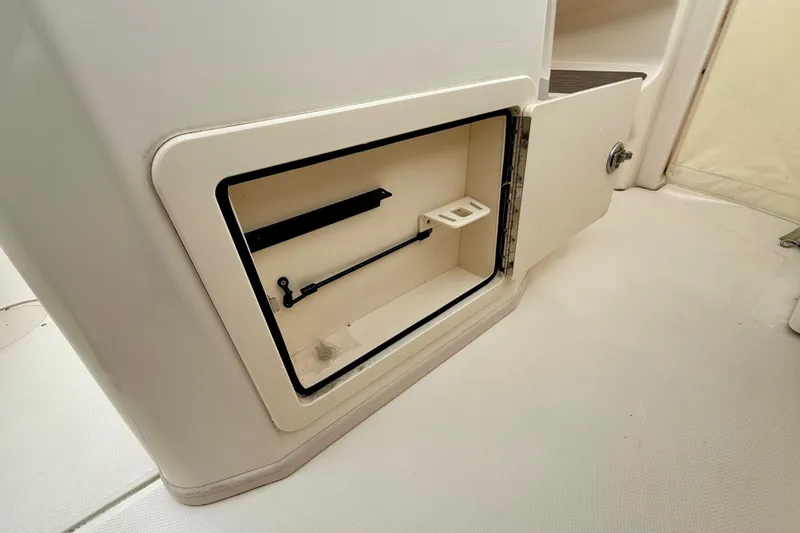 Neverland II Yacht Photos Pics 2022 Grady-White Canyon 271 storage compartment with open door, showcasing interior features.