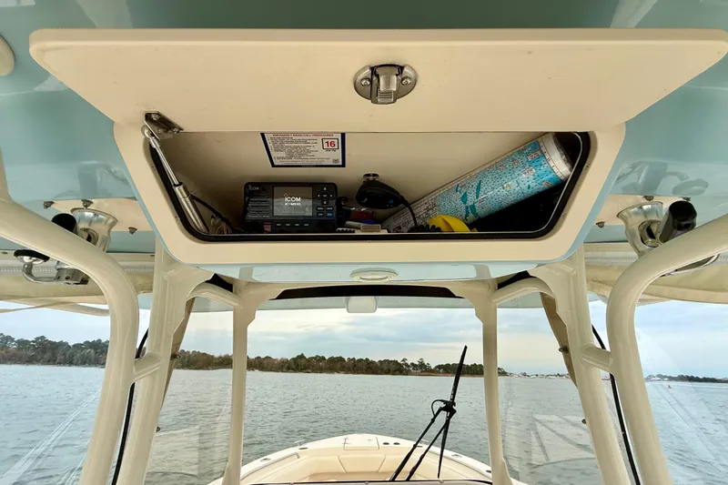 Neverland II Yacht Photos Pics 2022 Grady-White Canyon 271 boat console storage with radio and map.