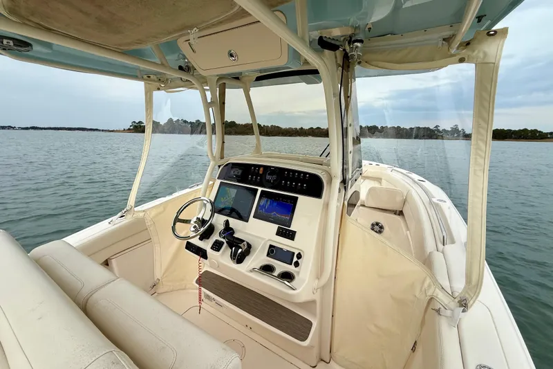 Neverland II Yacht Photos Pics 2022 Grady-White Canyon 271 boat interior with navigation equipment on calm water.