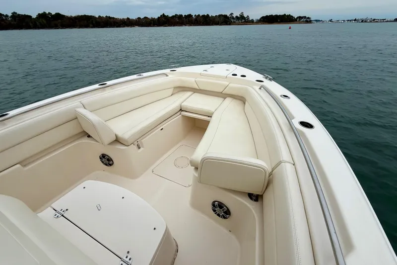 Neverland II Yacht Photos Pics 2022 Grady-White Canyon 271 boat interior with white seating, on calm water.